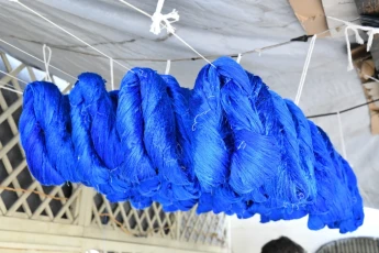 Hanging dyed silk to dry after washing it in cold water