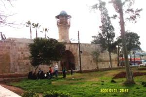Al-Madrasa as-Sultaniyya, exterior view of northern facade - entrance and minaret