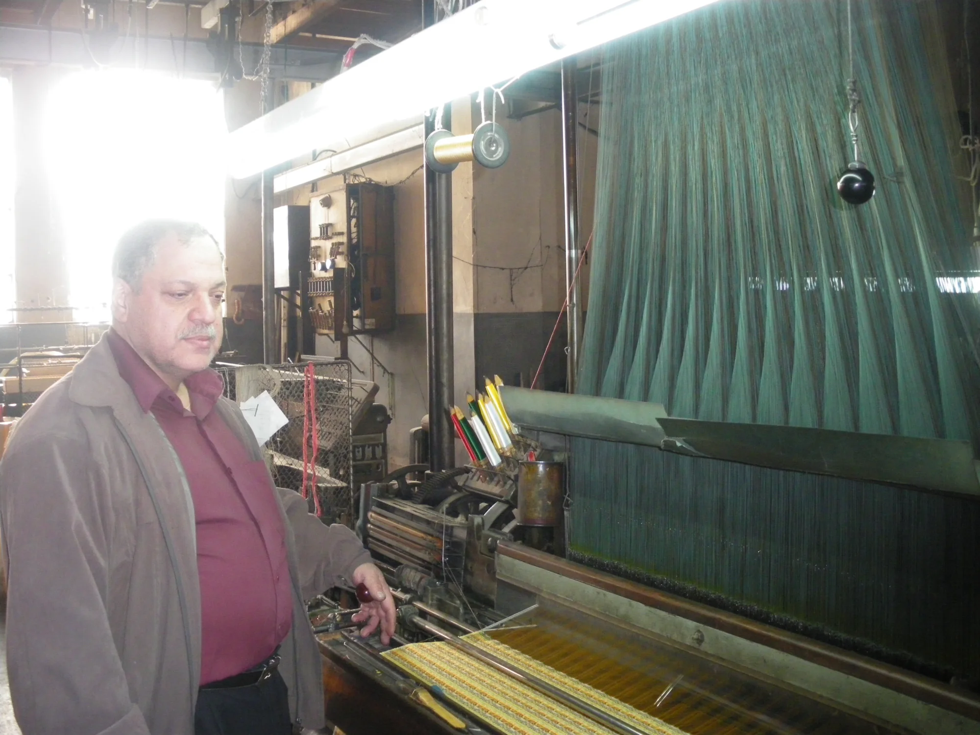 A mechanical loom in the textile factory of the Mezannar family