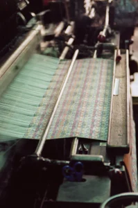 A mechanical loom in the textile factory of the Mezannar family