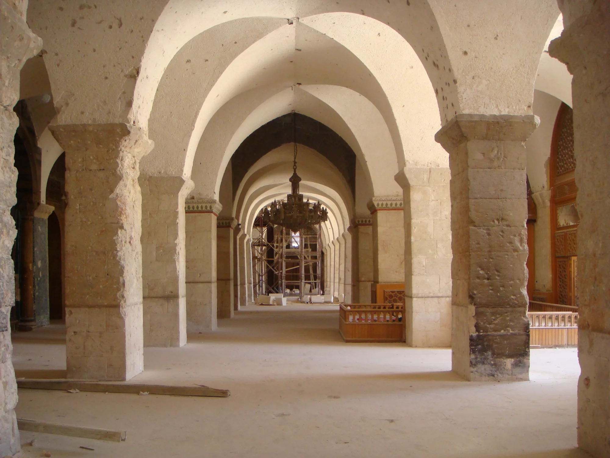 The interior of the war-damaged and cleared prayer hall of the Great Umayyad Mosque of Aleppo under restoration – view to the west