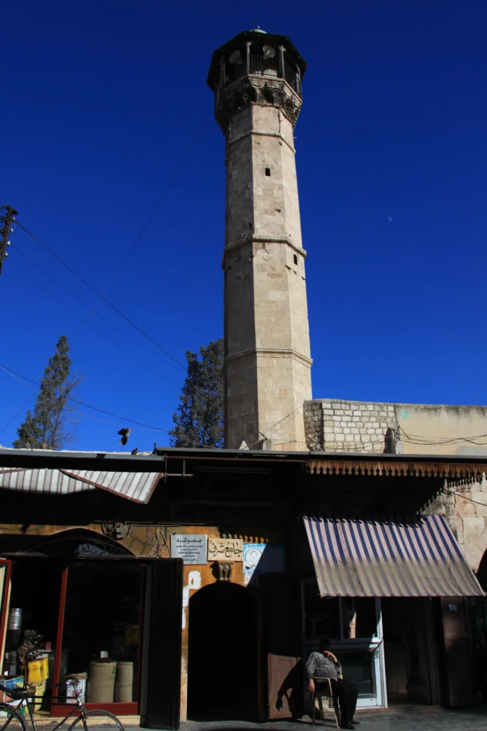 The minaret of the Jamiʿ Sharaf with street scene. The octagonal shape is typical for Mamluk mosques